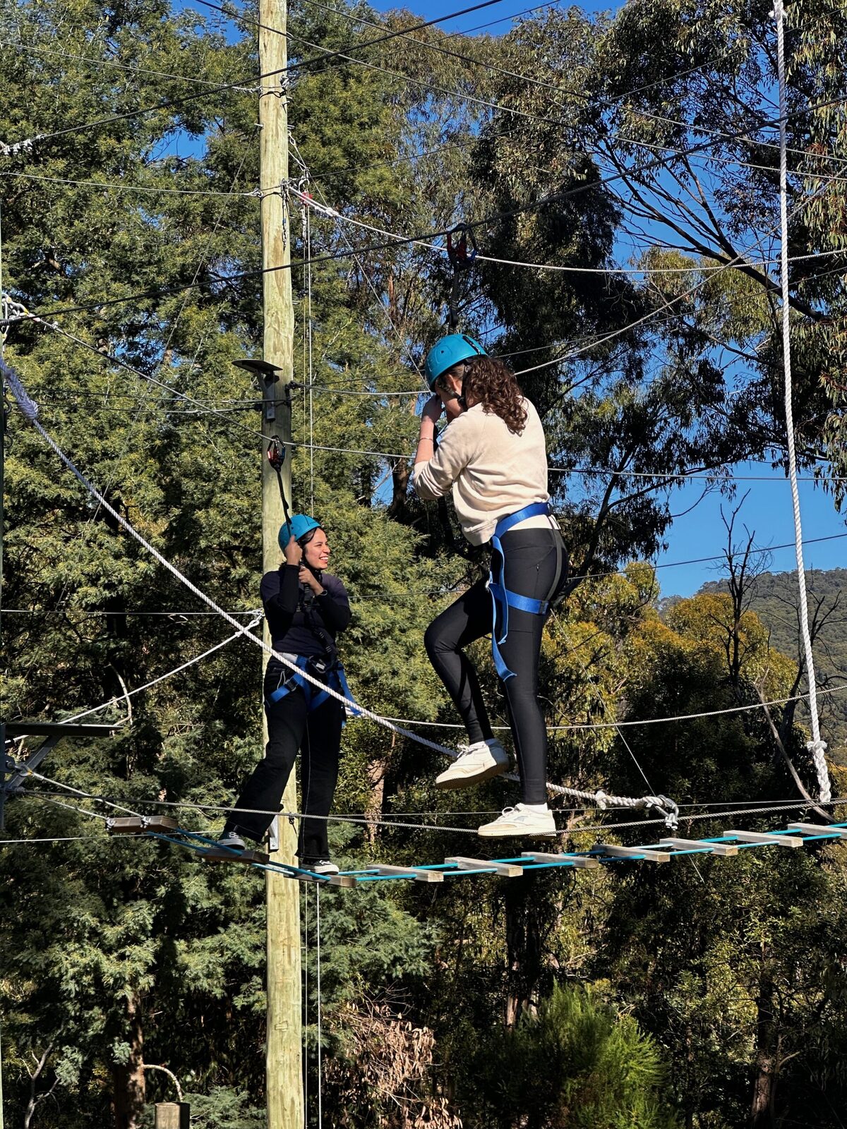A camper crossing the high ropes course at Oasis Camp