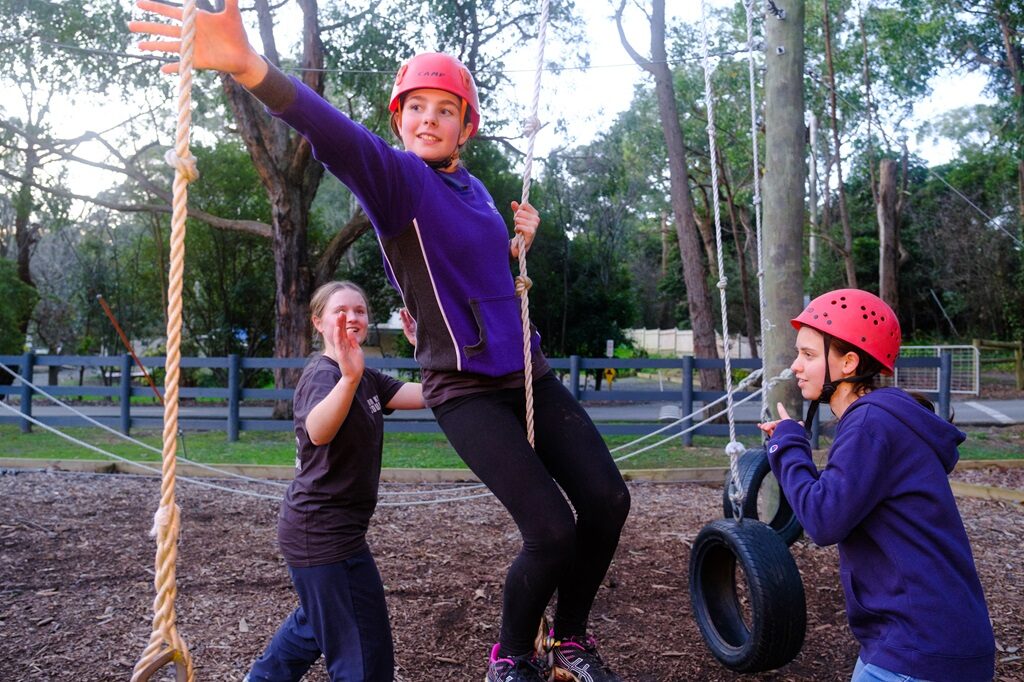 A group low ropes challenge at Oasis Camp