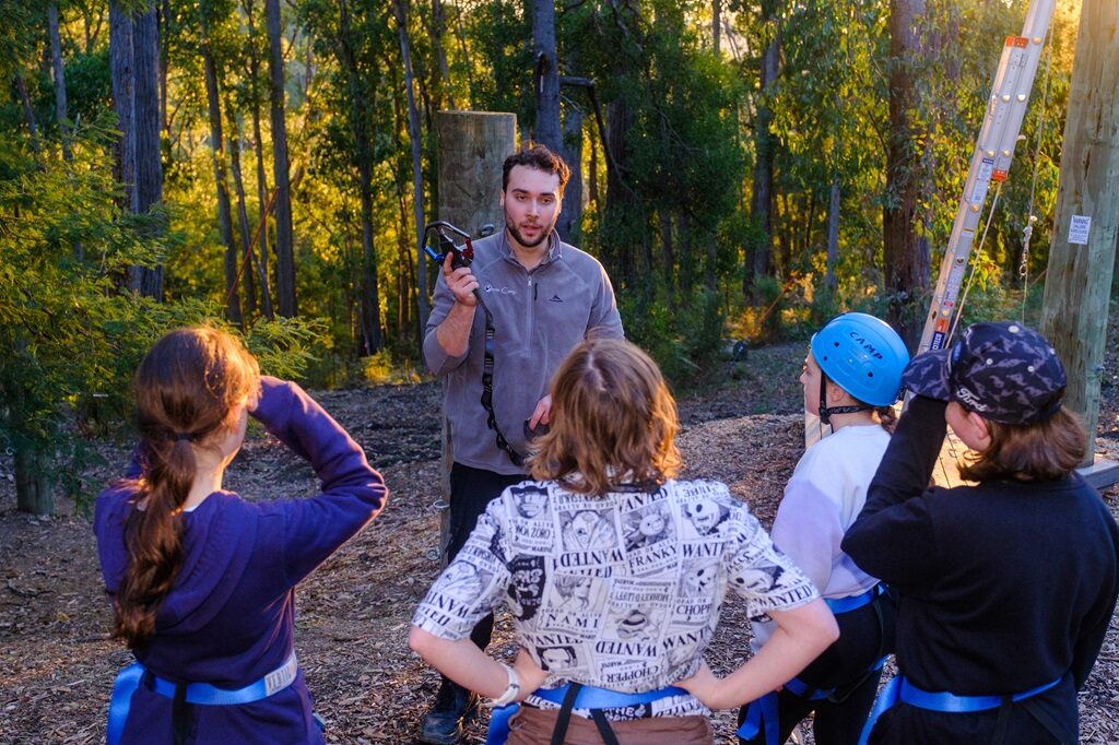 A team building low ropes challenge at Oasis Camp