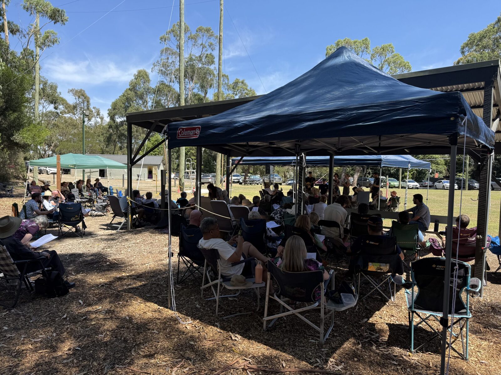 A church group gathered outdoors at Oasis Camp